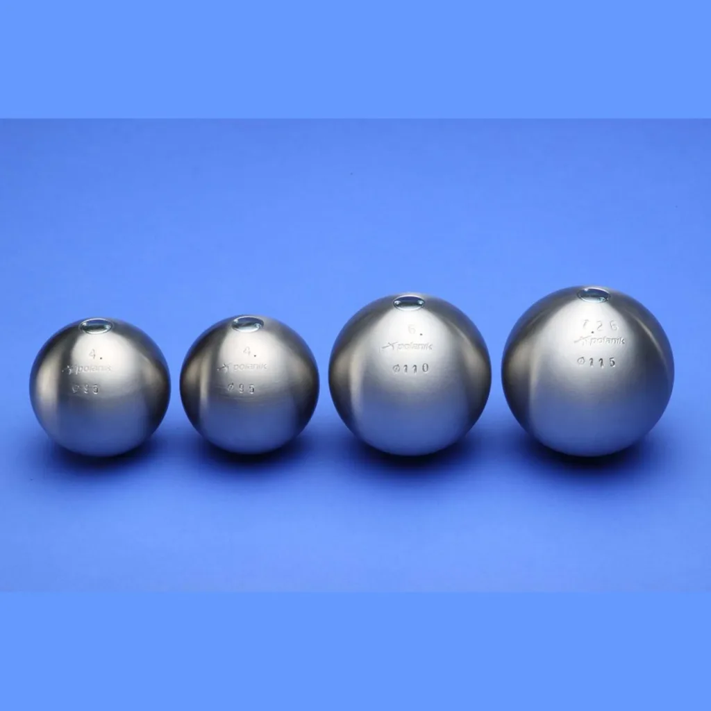 Four stainless steel shot puts of increasing sizes lined up on a blue background.