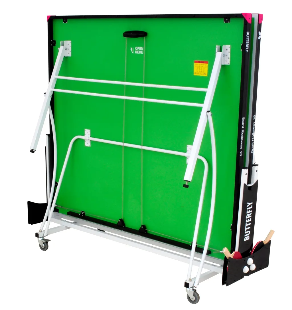 Folded table tennis table with green top, light silver legs and magenta corners, bat holder with 2 bats and 3 balls, and OPEN HERE label.