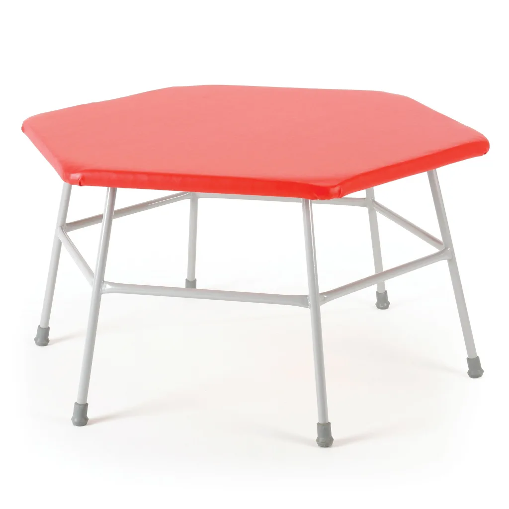 Hexagonal movement table with red vinyl-covered foam top, grey powder-coated steel frame and non-marking rubber feet.