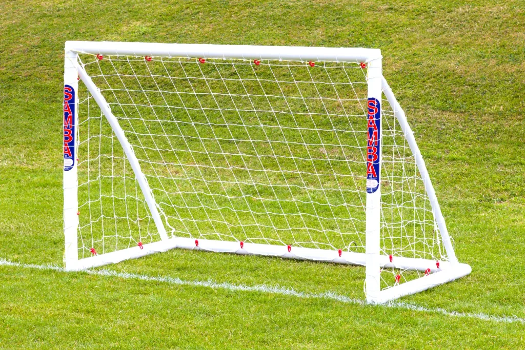A uPVC freestanding trainer goal with net and vertical SAMBA labels on the posts on grass.