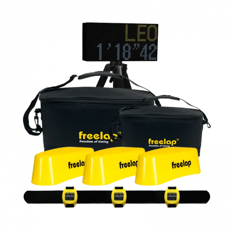 Black carrying bags, three yellow timing sensors labeled freelap, three yellow wrist units on a black strap, and an LED display reading LEO 1'18"42.