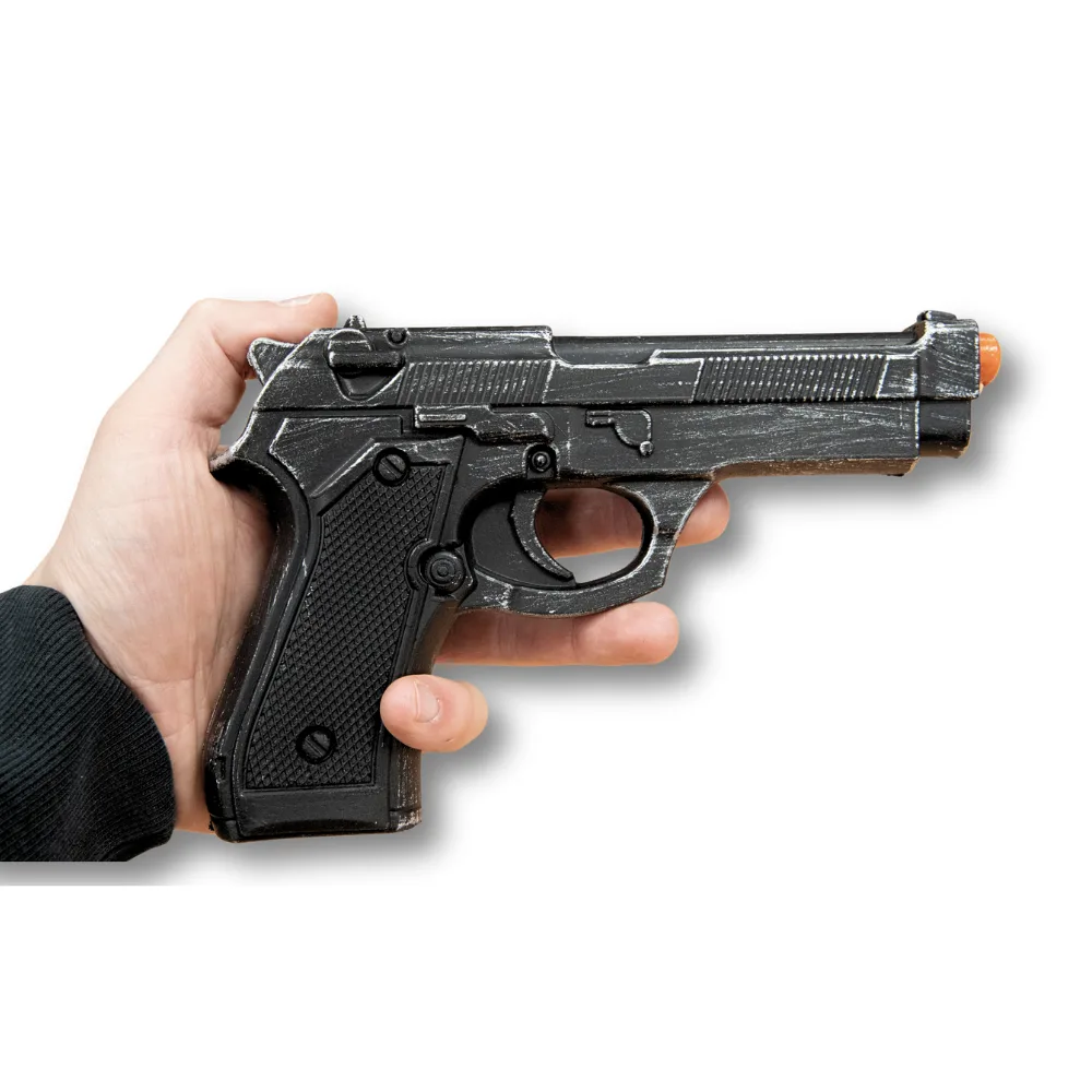 Hand holding a black realistic gun prop with an orange tip, used for police training.