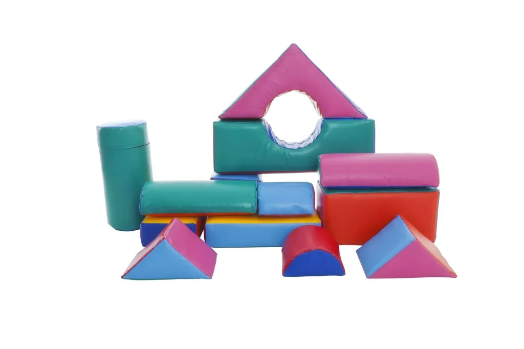 Children's construction kit of 14 assorted shapes in random colours arranged as a small play structure.