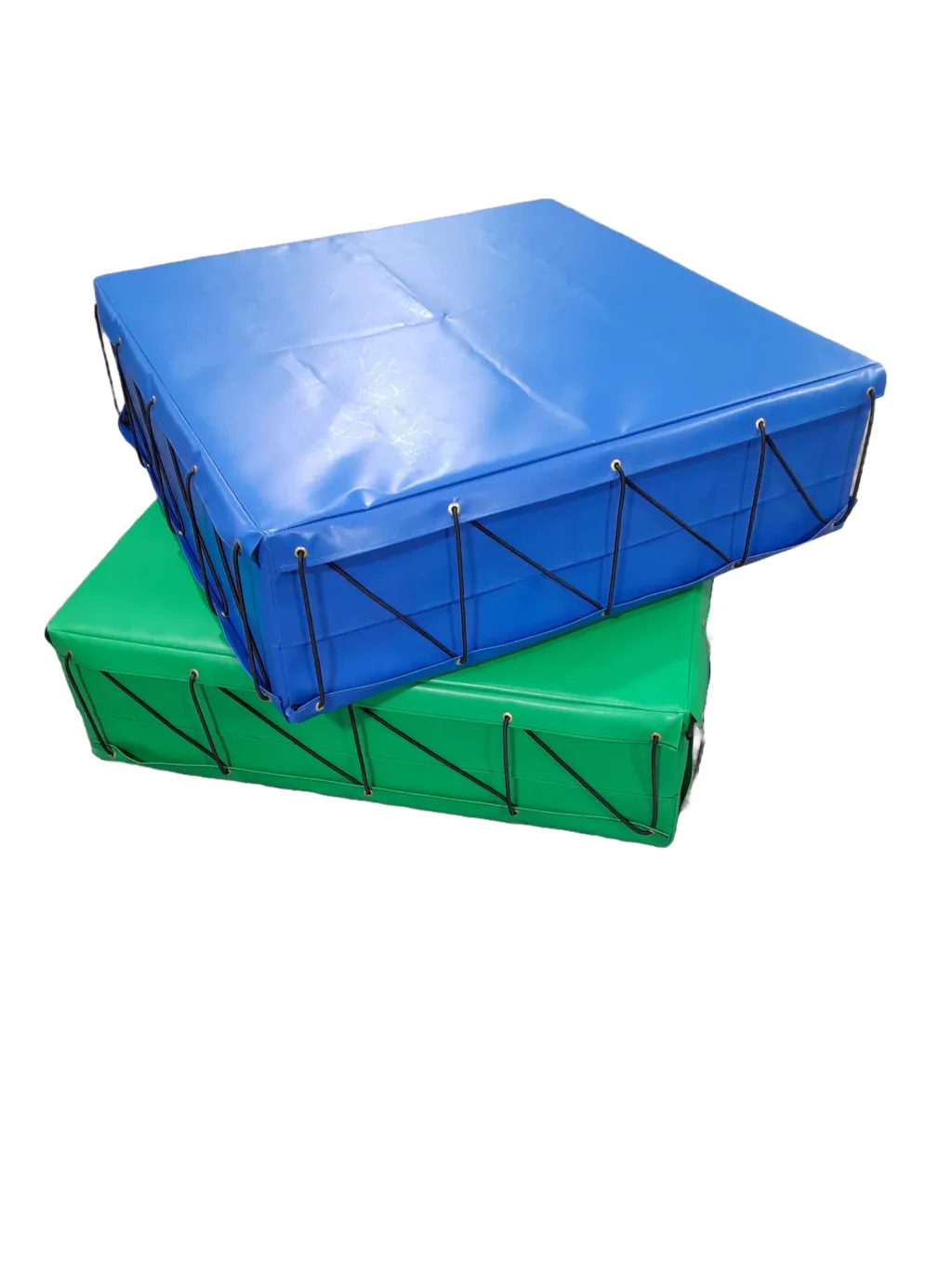 Two stacked foam keg mats with blue top and green bottom PVC covers, metal eyelets and black bungee cords around the edges.