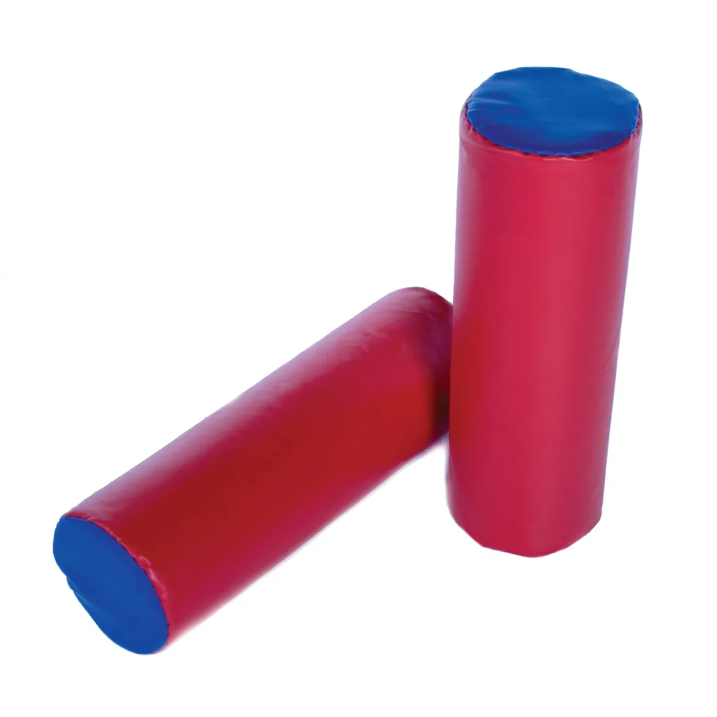 Two red cylindrical soft-play rolls with blue circular ends leaning on a white background.