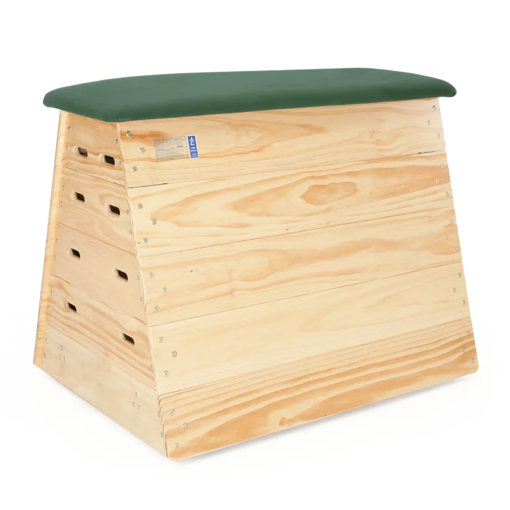 Five stacked timber sections form a vaulting box with a green hide padded top and recessed handholds.