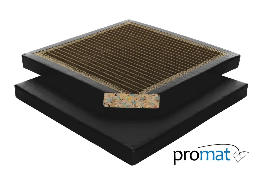 Black agility gym mat with leather-effect PVC cover and ribbed brown top, stacked to reveal a multicolored recycled chip foam core.