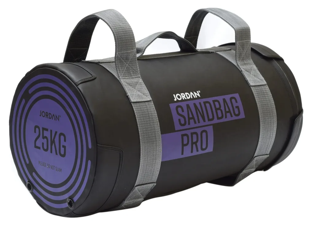 Black sandbag with grey webbing handles labeled "JORDAN", "SANDBAG PRO" and "25KG" with small text "PLEASE DO NOT SLAM".