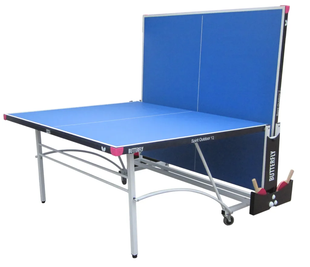 Blue spirit outdoor 12 table tennis table with one half folded upright, light silver steel legs, magenta corner pieces and paddle-and-ball holder.