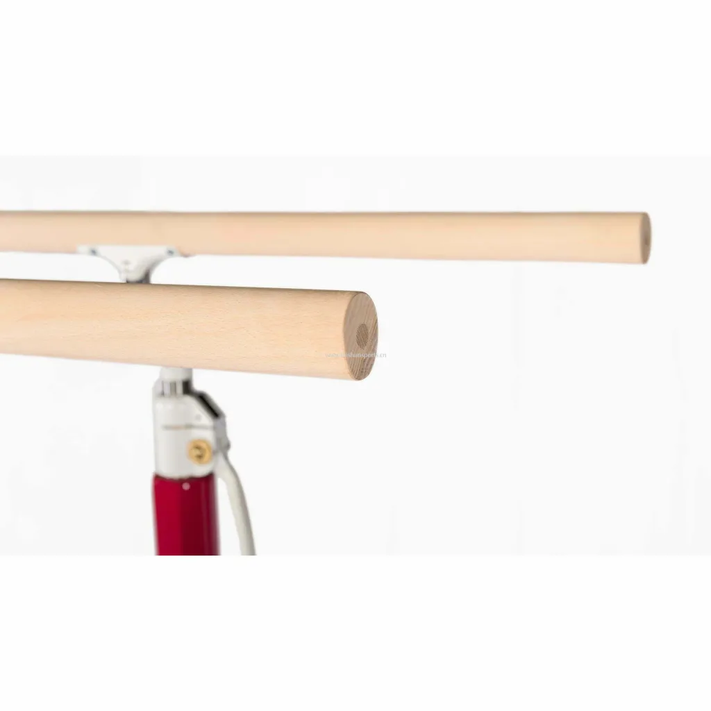 Competition parallel bars with maple-wrapped fiberglass rails mounted on a red and white adjustable metal base.