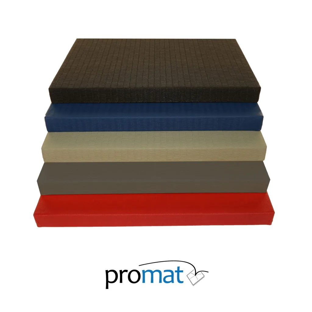 Stacked contest judo mats in black, blue, green and red with tatami embossed PVC covers, waffle material bases, and a visible promat logo.