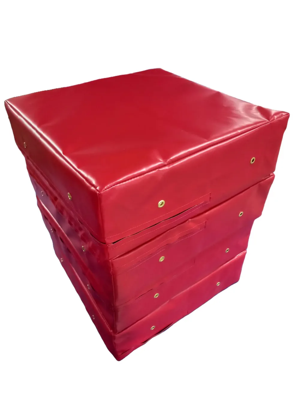 Red weightlifting drop pads stacked three-high with heavy-duty fire retardant PVC covers and brass eyelets.