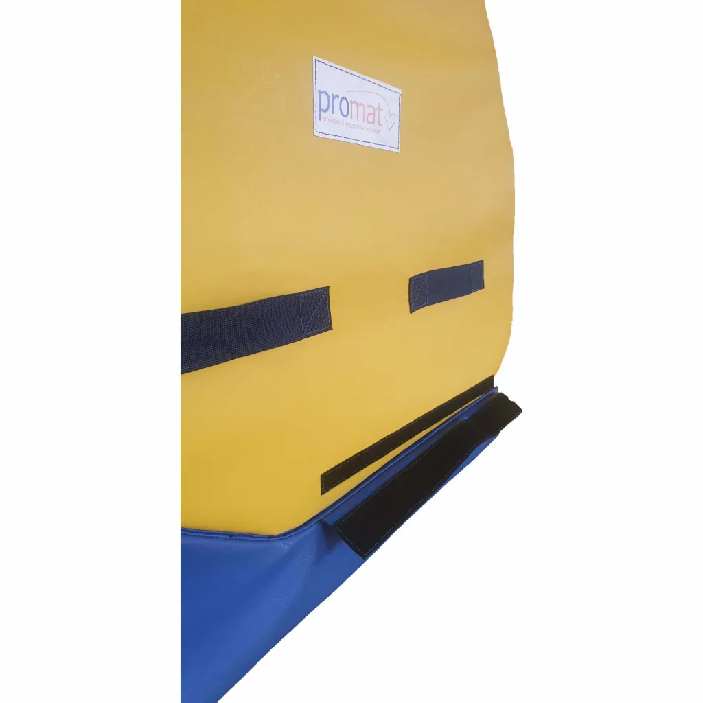 Top tumbler with yellow flame-retardant PVC cover over PU foam, black carry straps and Velcro, sitting on a blue base.
