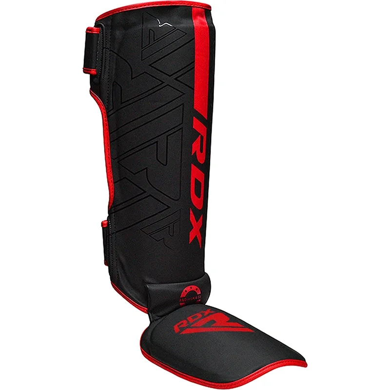 Black shin and instep guard with red trim and RDX printed on the front.