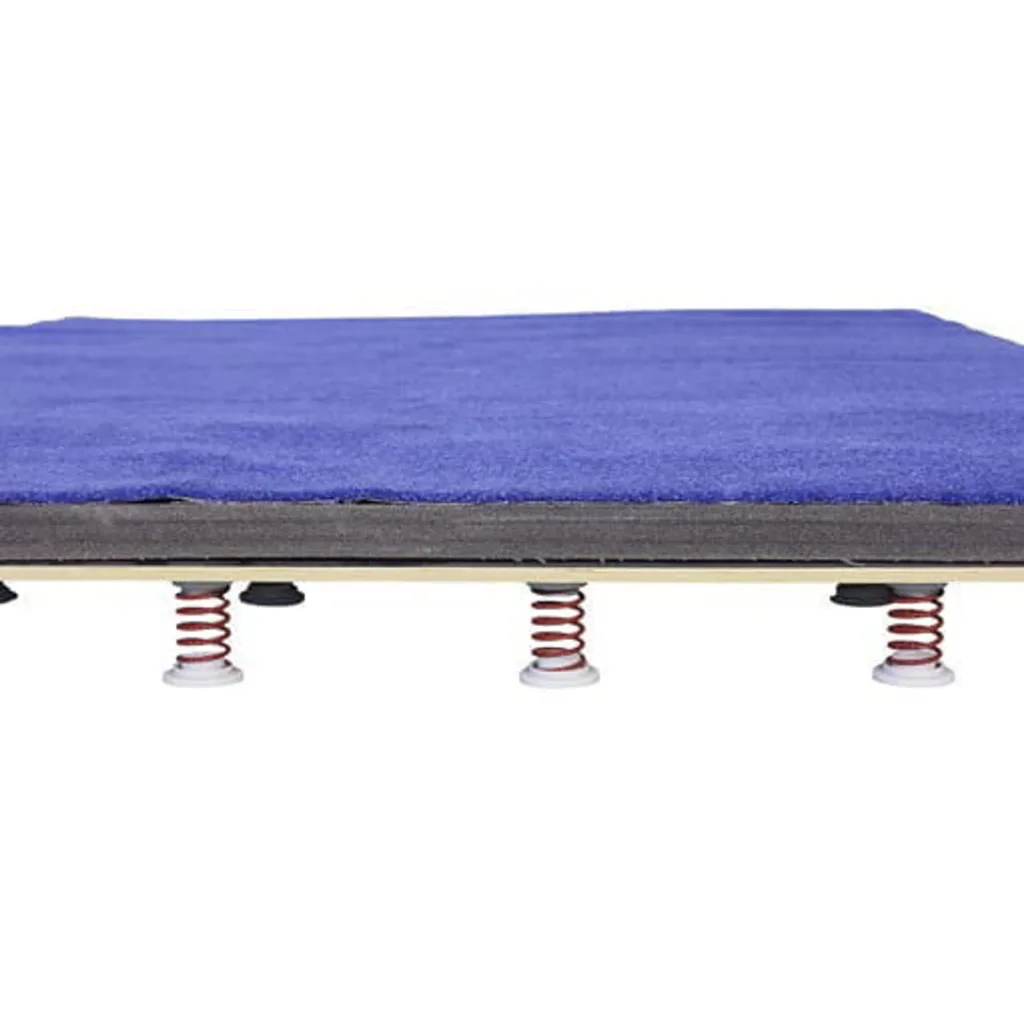 Blue tumbling board with XPE foam surface on a sprung base showing red coil springs underneath.