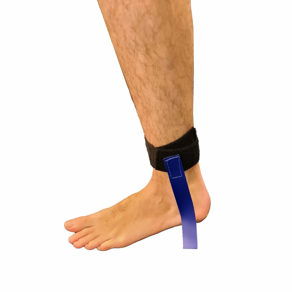 Lower leg and bare foot wearing a hook-and-loop ankle strap with a hanging blue wrestling tag.