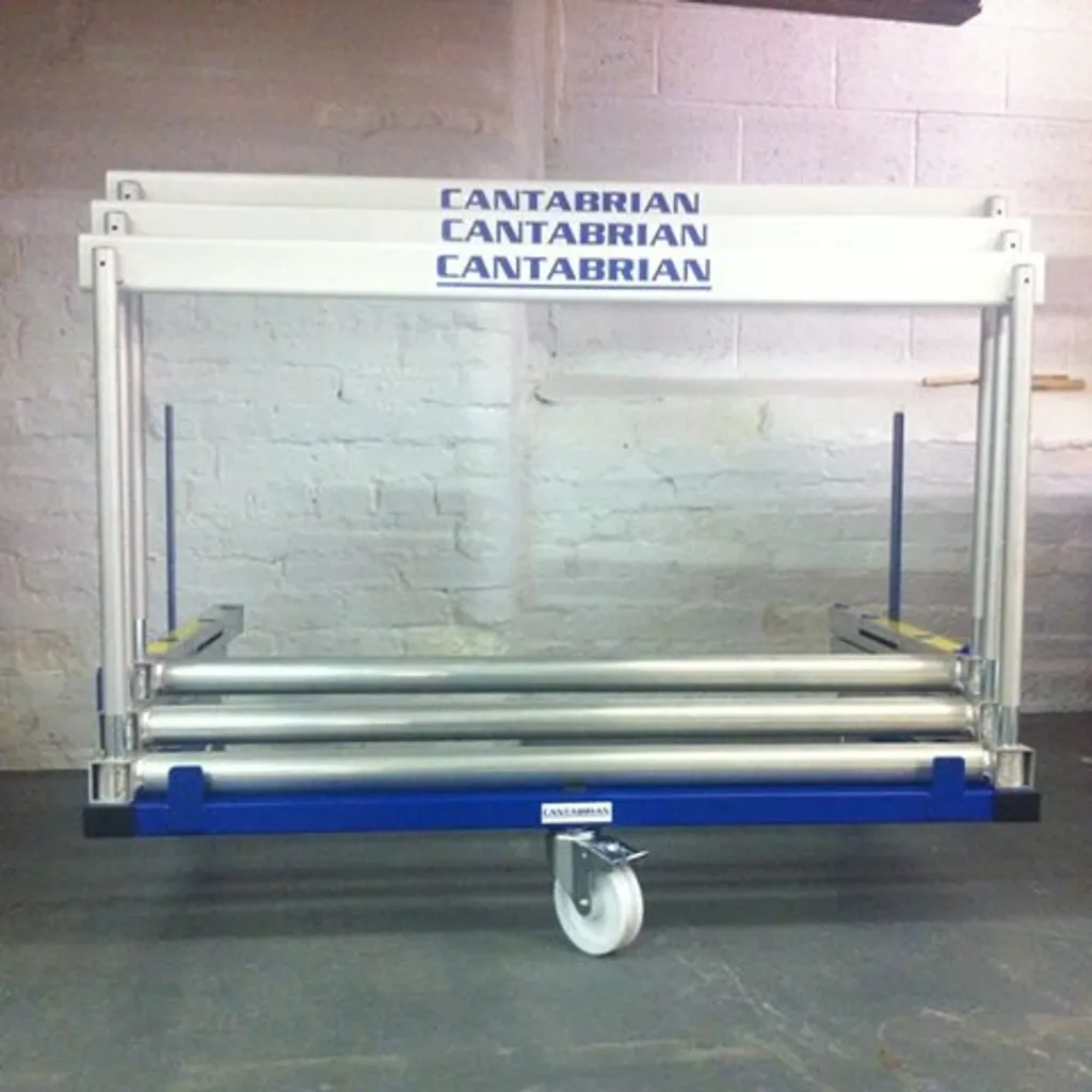 White polyester powder-coated steel hurdle trolley with blue base holding stacked silver hurdles and 'CANTABRIAN' printed on the top bars.