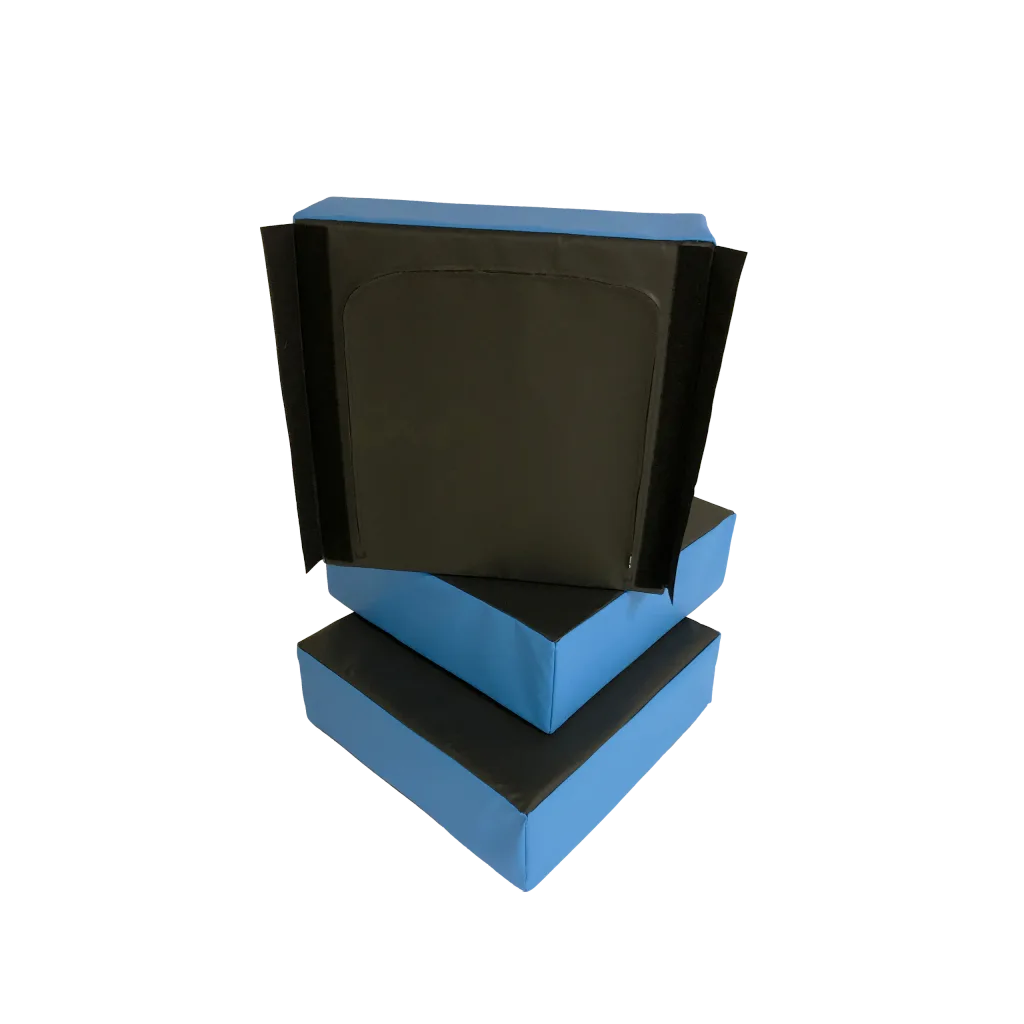 Three blue foam stepping blocks with black tops stacked, one upright showing hook-and-loop strips on its side.