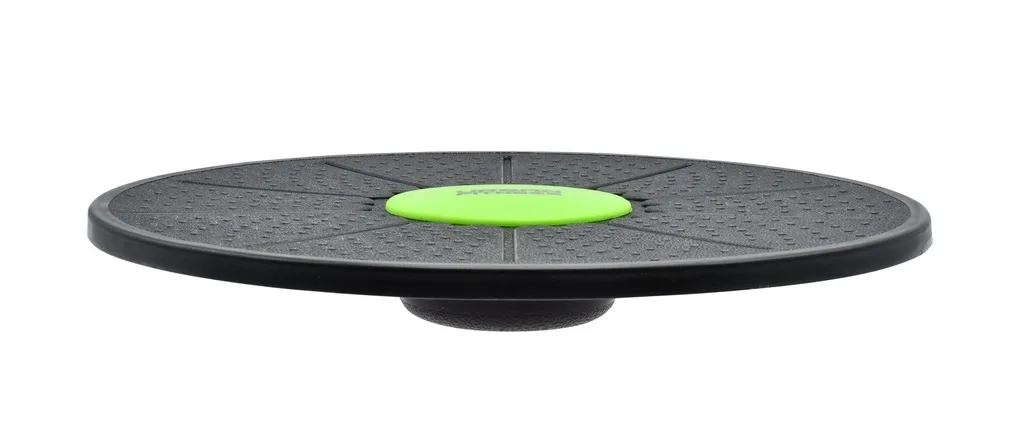 Black circular balance board made from heavy-duty plastic with a textured surface, small green center pad, and rounded base.
