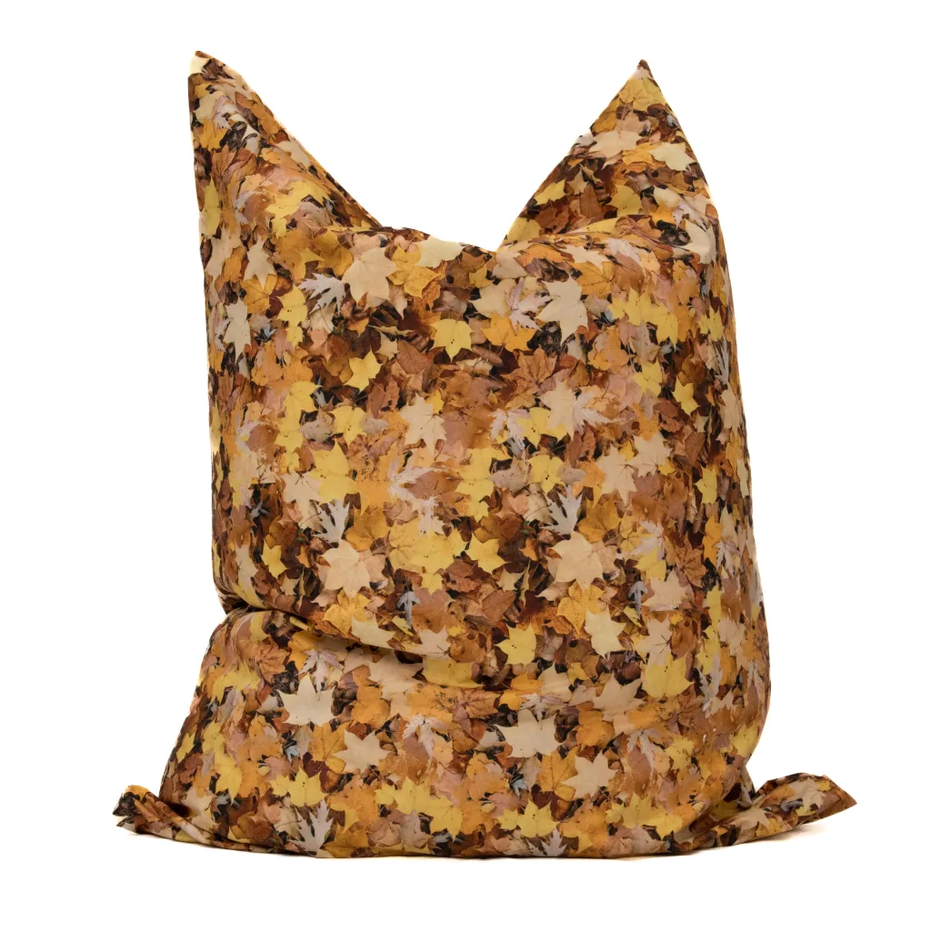 Large floor cushion with nature-print yellow and brown fallen leaves and a 100% polyester outer cover.