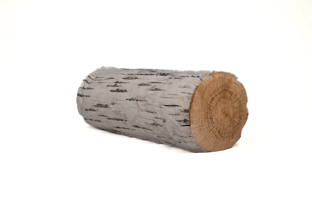 Log-shaped cushion in birch design with grey bark pattern and visible wood end, photographed on a white background.