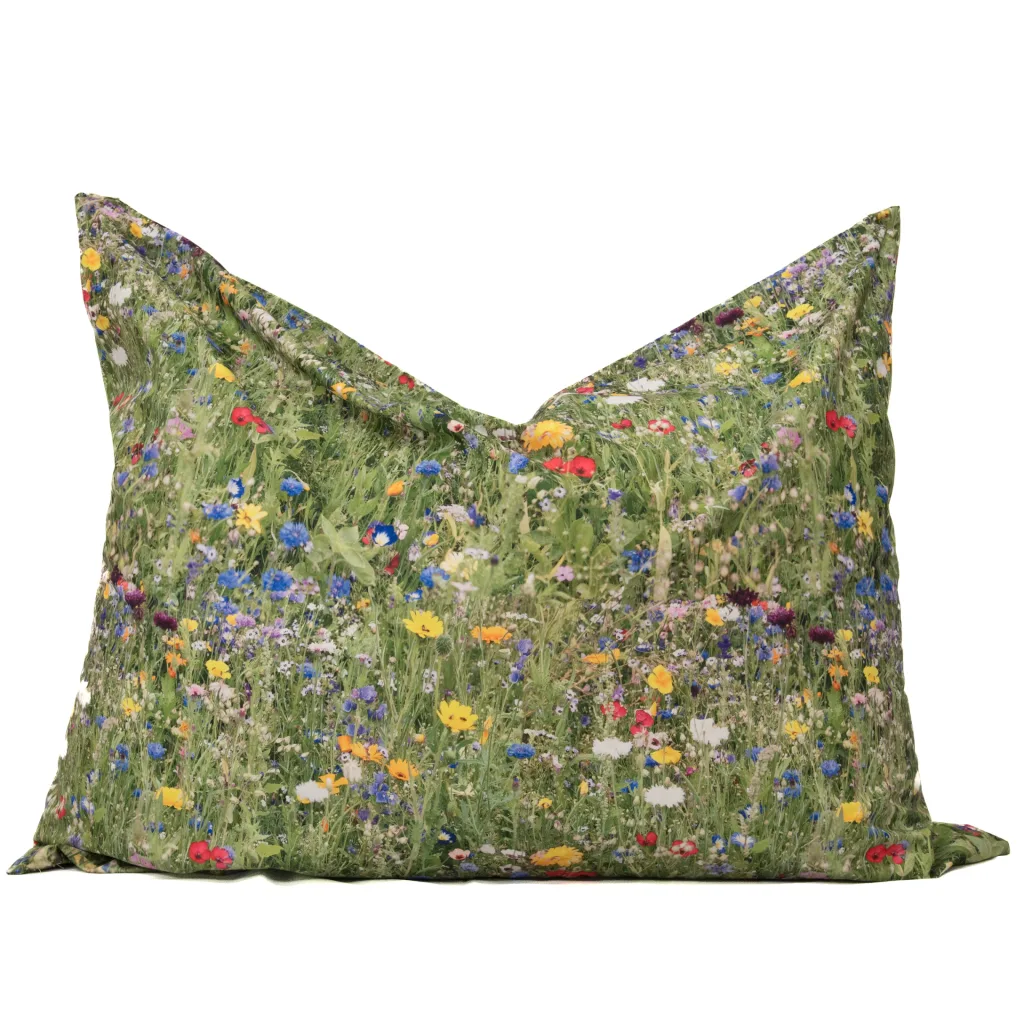 Plush cushion with 100% polyester outer cover featuring a green meadow wildflower nature print.