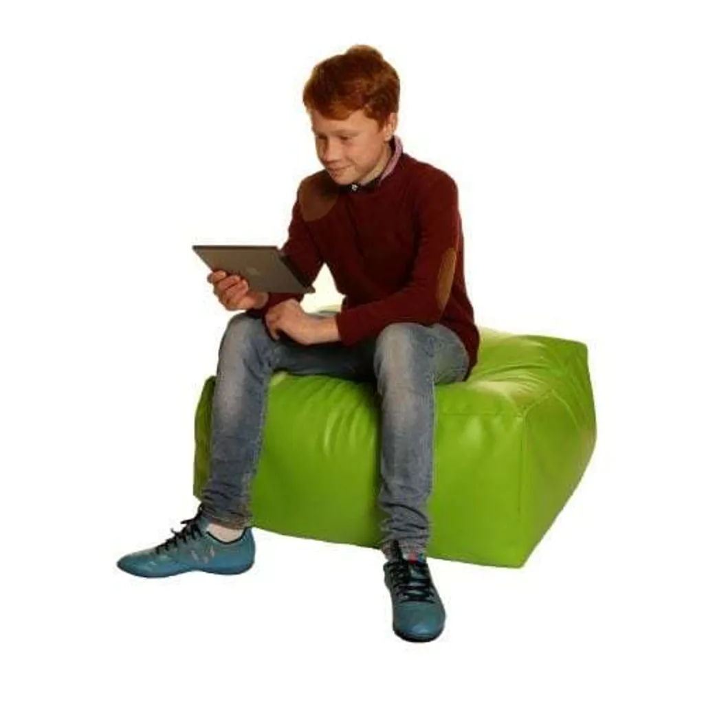 Child sitting on a green cotton square bean bag while using a tablet.