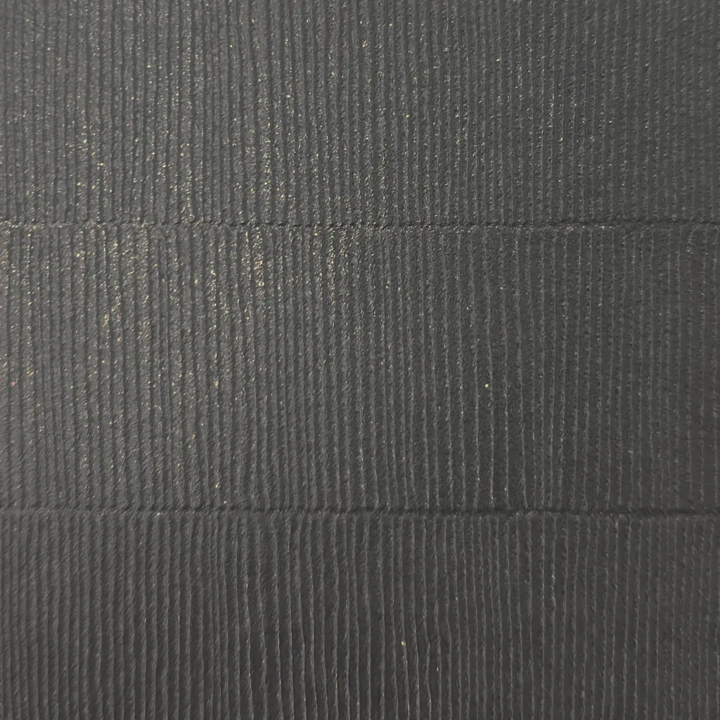 Dark PVC mat with fine vertical tatami emboss ridges and two horizontal seam lines across the surface.