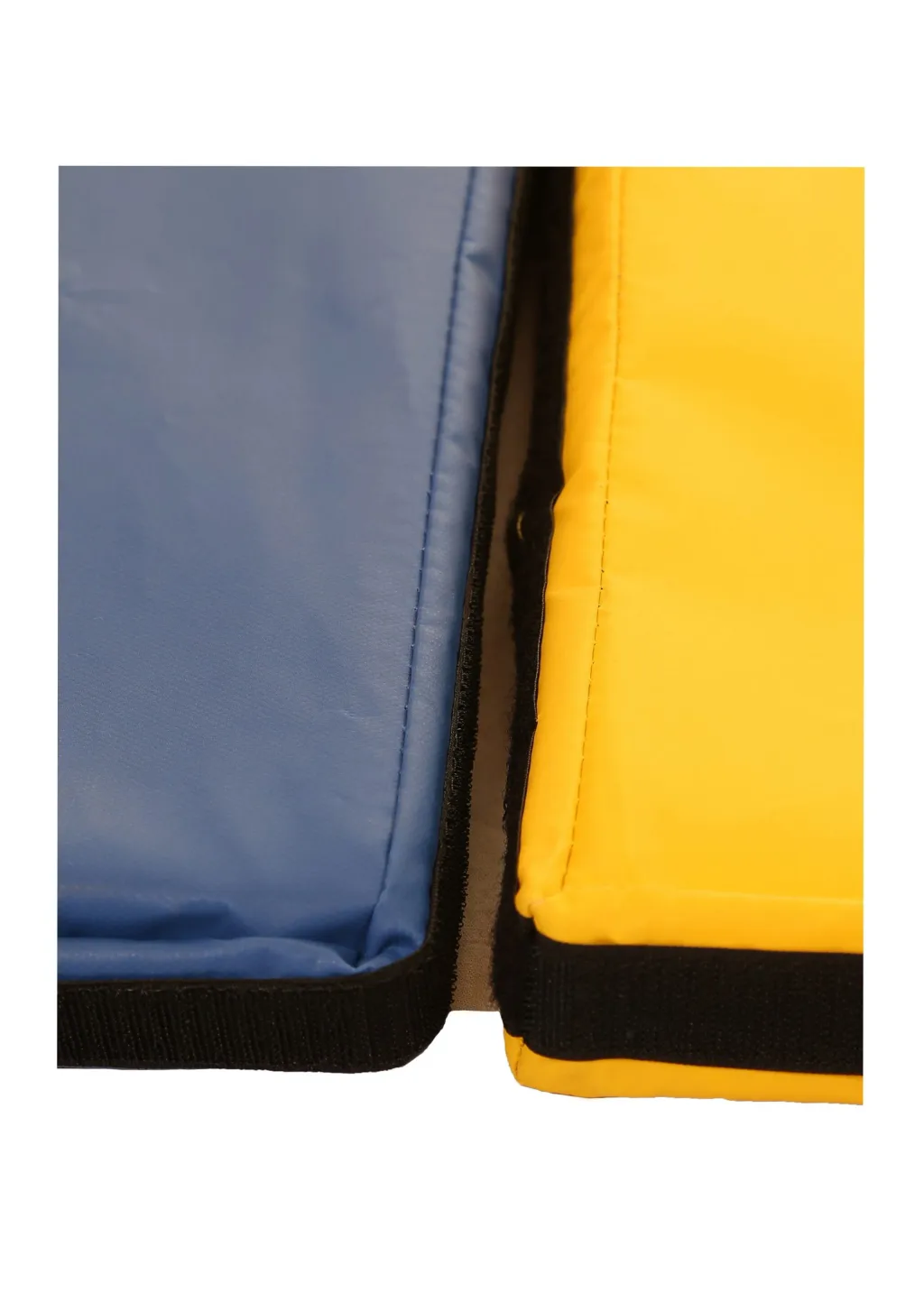 Blue and yellow tumble mats with black hook-and-loop link and flap at the seam and heavy-duty PVC covers visible.