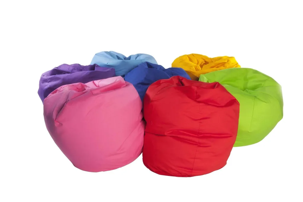 Cluster of cotton bean bags in red, purple, yellow, pink, royal blue, turquoise and lime arranged together.
