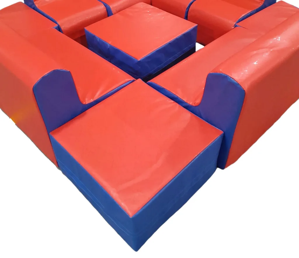 Red and blue foam-filled children's corner seating set with two sofas, a chair and a cube pouffe with PVC covers.