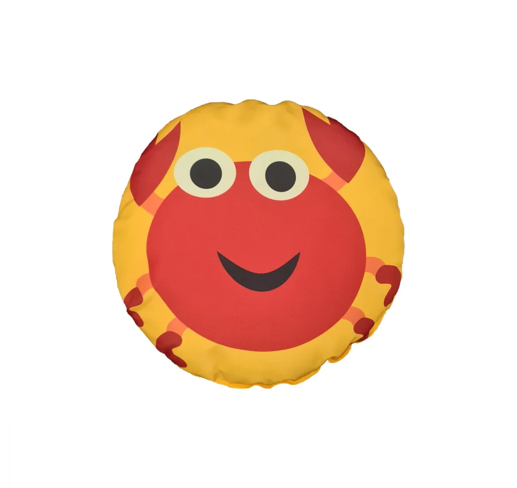Round yellow fibre-filled scatter cushion with a red crab face, cream eyes and a black smiling mouth.