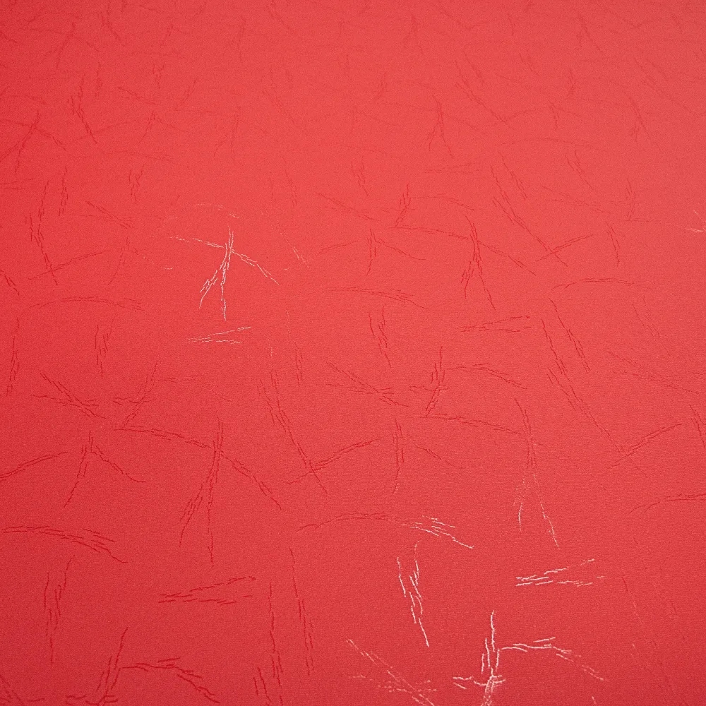 Red tatami-finish high-density foam mat surface with subtle textured lines and a few light scuff marks.