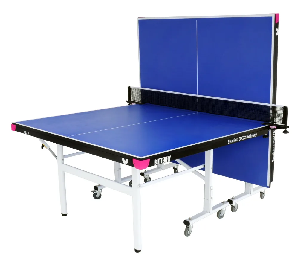 Foldaway blue table tennis table with light silver steel legs, magenta corner pieces, black net and one half folded upright on wheels.