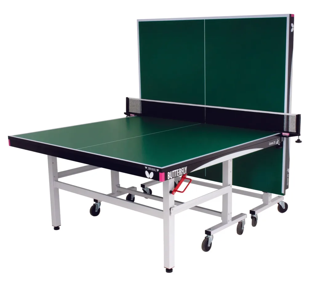Green playing-top Octet 25 table tennis table with two upright halves, magenta corner pieces and light silver legs on wheels.