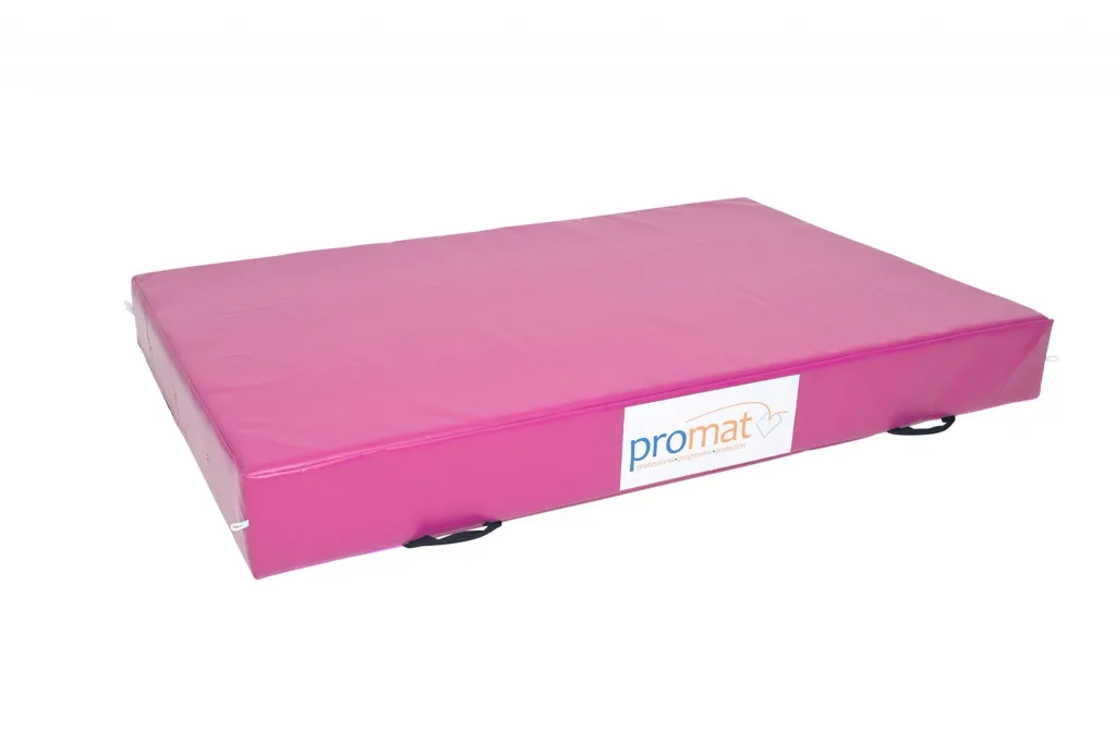 Pink crash mat with a zipped PVC cover, black carrying handles and a white label reading promat.