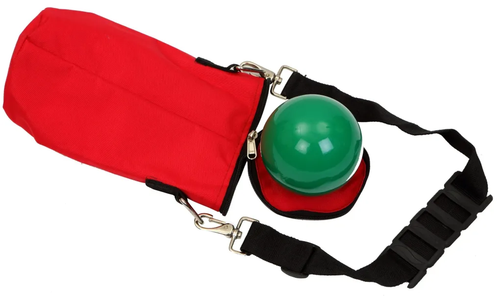 Red vinyl shot put bag with a black padded shoulder strap is unzipped to reveal a partially exposed green shot put.
