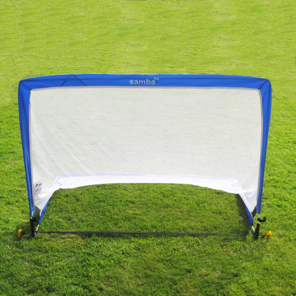 Blue pop-up soccer goal with white net and samba printed on the top, positioned on green grass.