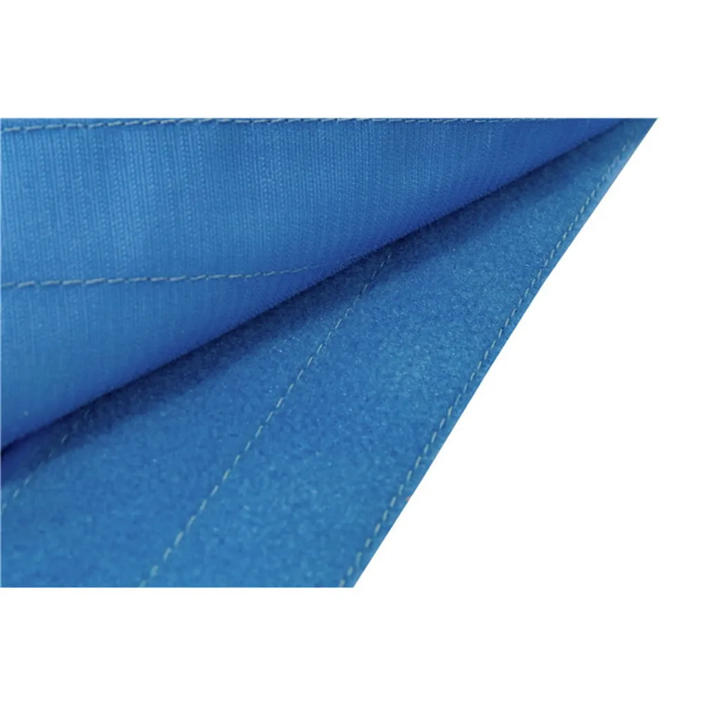 Close-up of blue uneven bars landing mat corner showing folded layers, stitched seams, and textured fabric.
