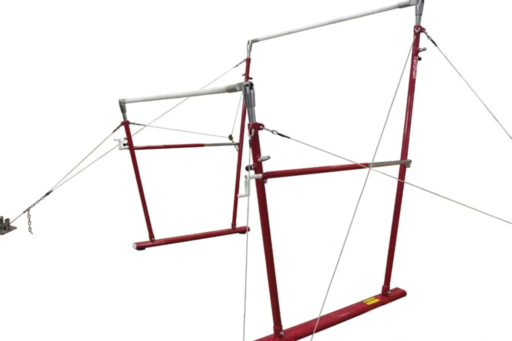 Red-framed uneven bars with fibreglass rails wrapped in beech veneer, adjustable uprights and tension cables.