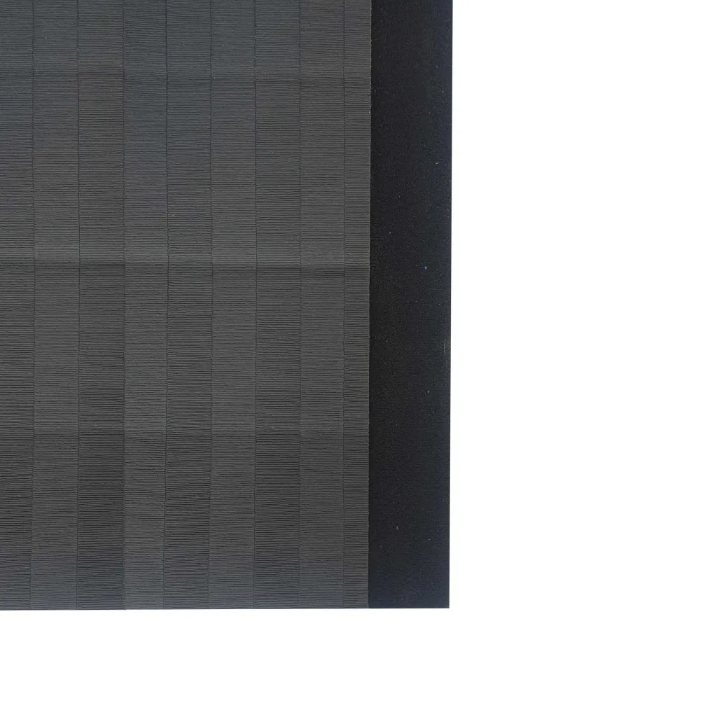 PVC roll-out mat with low-profile tatami emboss, visible grid texture, and a dark hook-and-loop connecting edge along the right side.