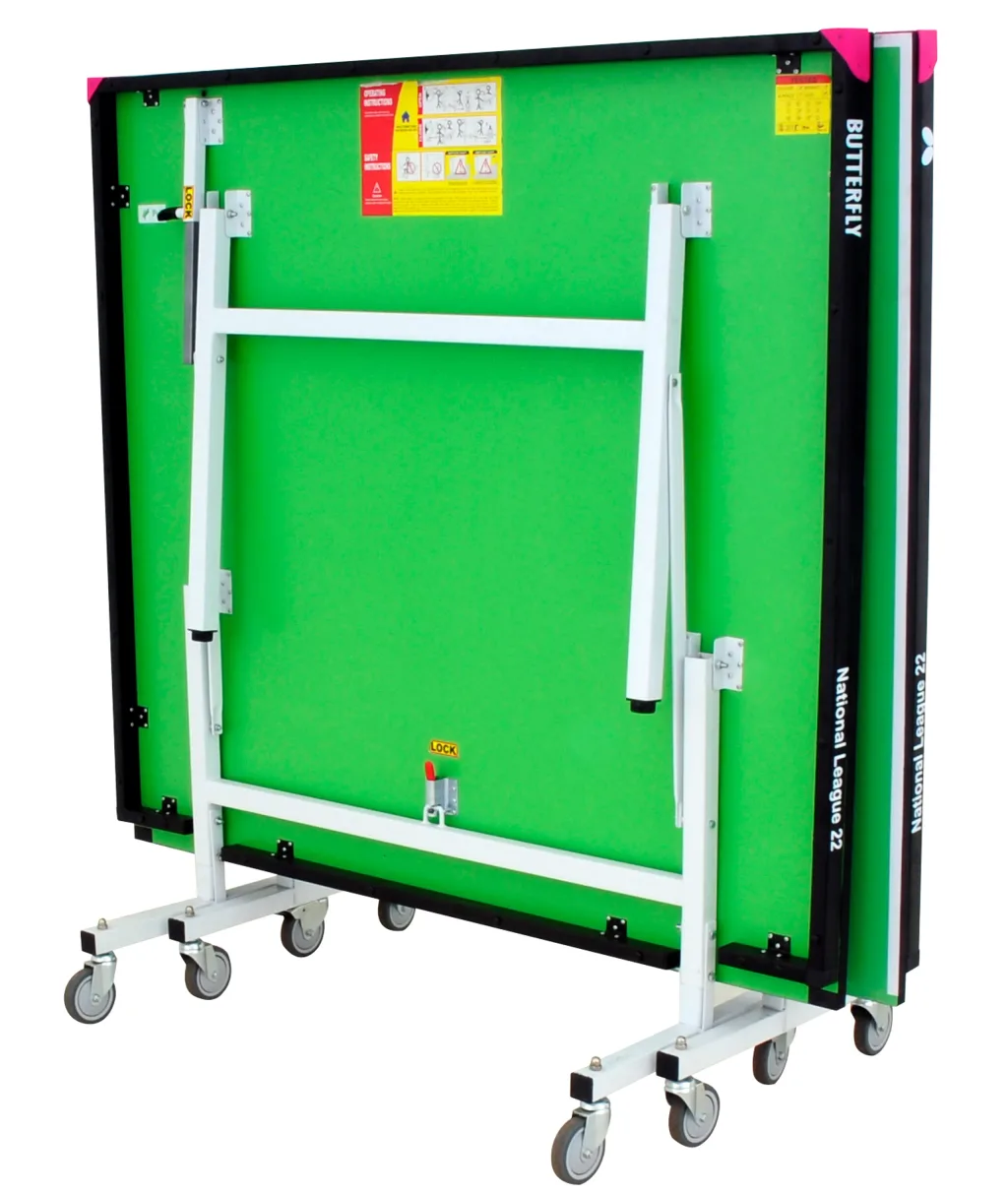 Folded green table tennis table with light silver legs and undercarriage, magenta corner pieces, eight caster wheels, and visible text "National League 22".