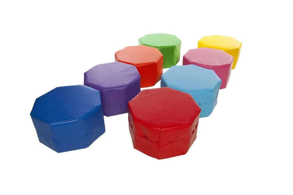 Eight octagonal foam seats with PVC covers in random colours arranged in two staggered rows.