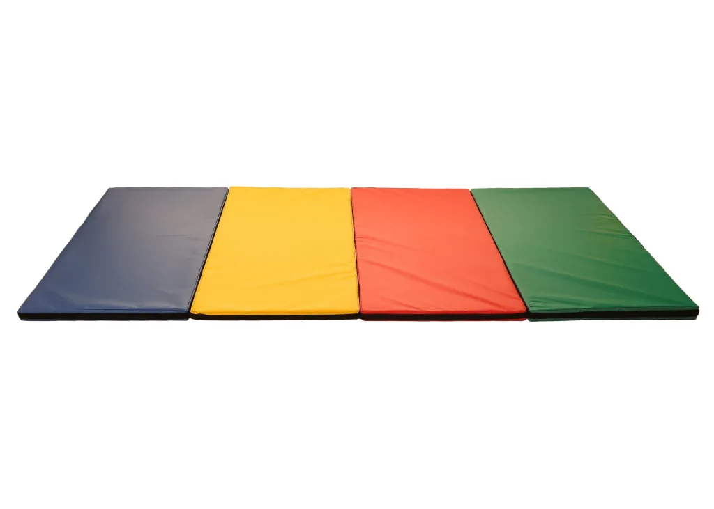 Four rectangular tumble mats with heavy-duty flame-retardant PVC covers in blue, yellow, red and green laid side by side and joined by velcro.