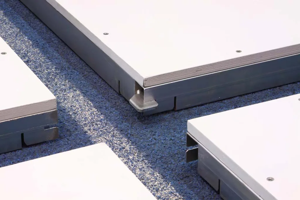 Indoor throwing circle quadrants with white plywood tops screwed to galvanised steel frames resting on a blue granular track surface.