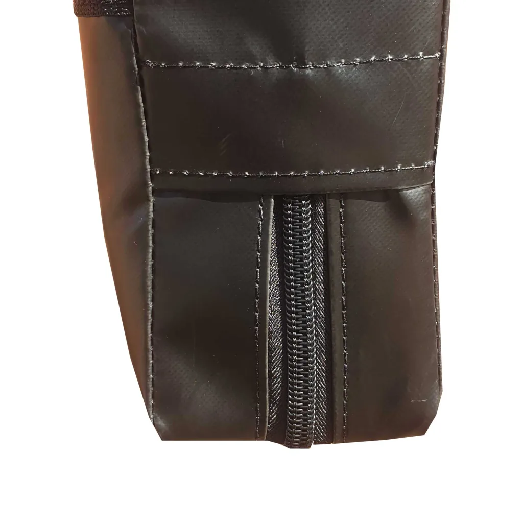 Close-up of a black PVC strike pad corner showing stitched seams and a central vertical zipper.