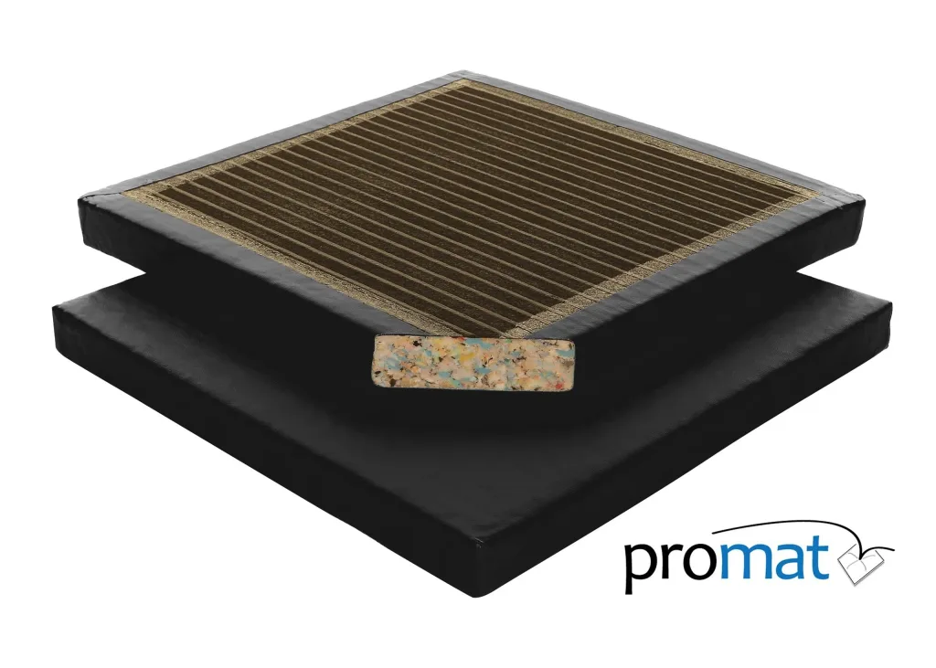 Black PVC-covered agility mat with brown ribbed top and exposed multicolored chipfoam core, stacked with one piece offset and the text promat visible.