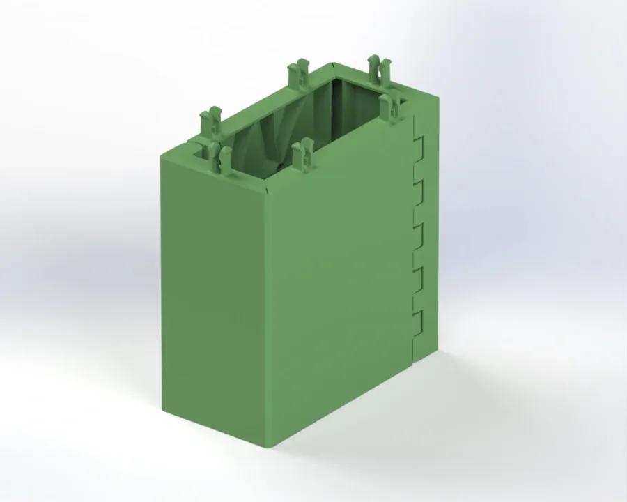 Green rectangular modular training block with hinge-style interlocks on one side, four top clip connectors, and an open hollow interior.