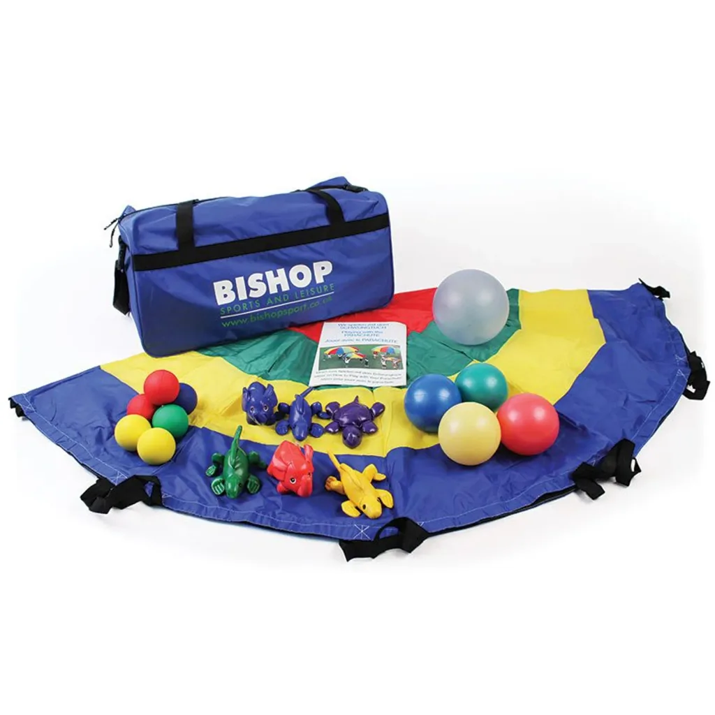 Colorful parachute spread on the floor holding multicolored foam balls, six small animal bean bags, a clear jinglin’ ball, and a blue carry bag.