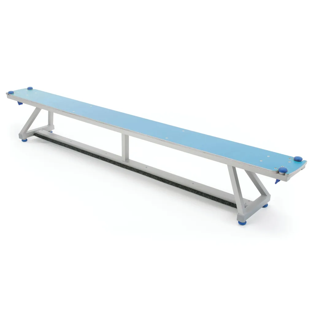 Long aluminium Lita bench with an upholstered top, rubber feet for grip and visible corner bumpers on folding support legs.